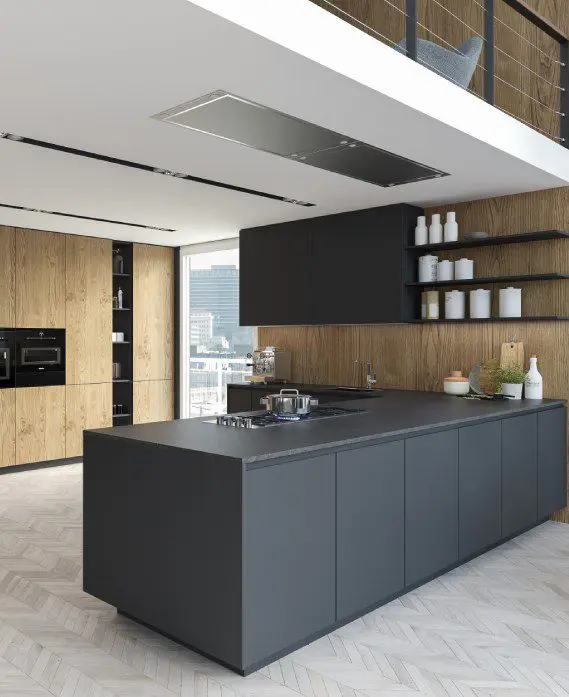 A kitchen with a large island and wooden cabinets.